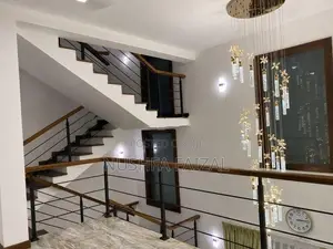 Staircase steel railings with teak handrails